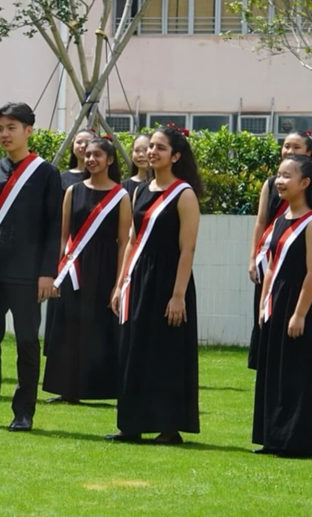 Tara singing outdoors with choir members